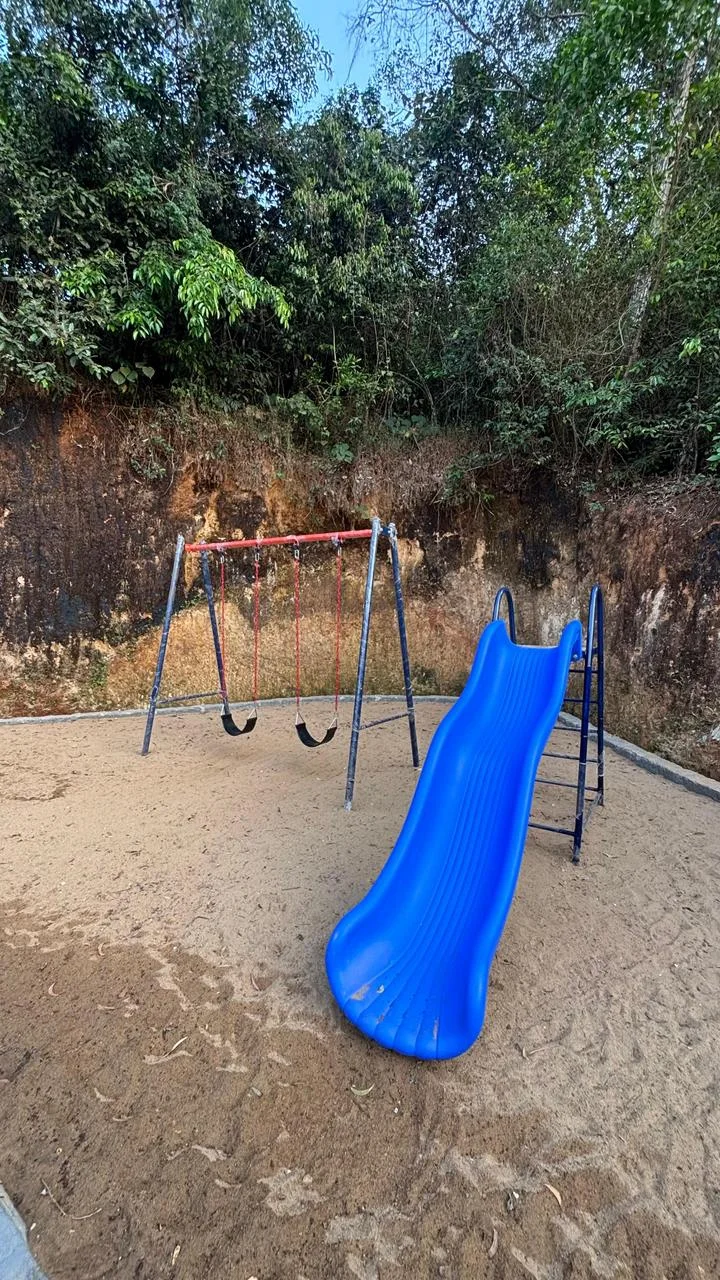 Children's play area with swings and slide